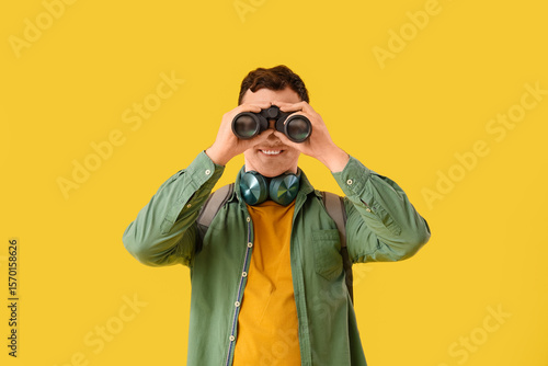 Young man with binoculars o...