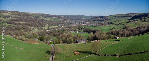 aerial panoramic view of the calder valley with the village of mytholmroyd visible surrounded by meadows and trees