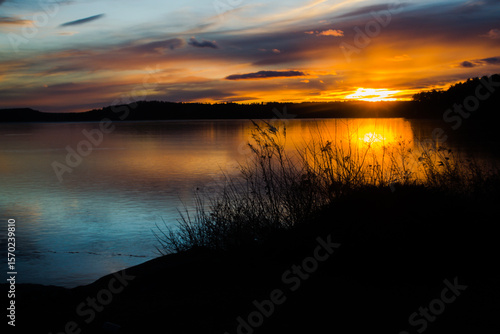 Sunset reflects on early winter ice on Lake Auburn, Auburn Maine.  
