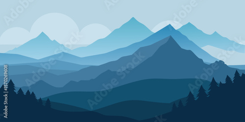 Misty blue mountain peaks at sunrise with a cloudy sky