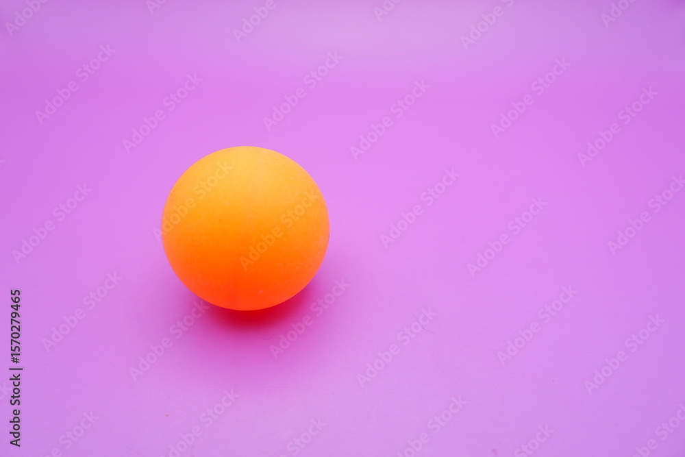 Fototapeta premium Ping Pong Ball on a Pinkish Purple Background