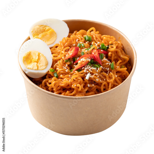 Spicy Korean dried instant noodles with boiled egg, sliced scallions, sesame seed and fresh chili in kraft paper bowl