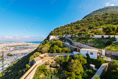 Moorish defensive walls and World War II tunnels on the Northwest side of the Rock of Gibraltar with the Mediterranean Sea and Spanish coastline in view, in Gibraltar, UK.