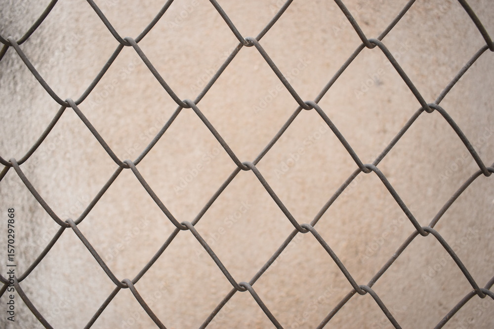 Fototapeta premium old wire mesh on dirty wall, construction industry