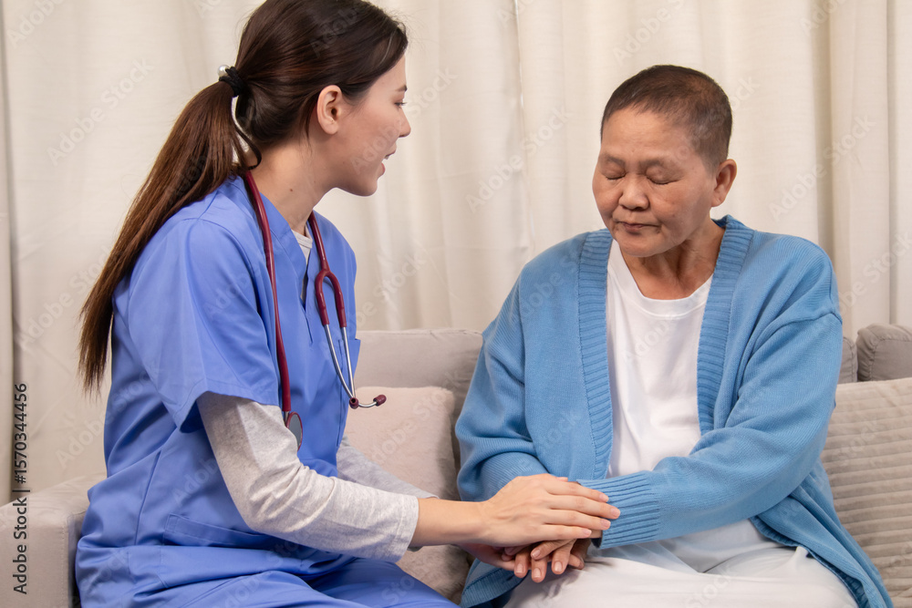 Obraz premium Young female nurse holding hands with senior woman, both smiling with trust and warmth during health support session in cozy home setting, healthcare, caregiver, take care, consult.