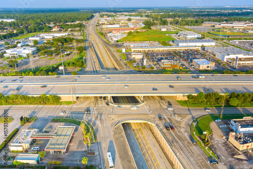 Wall Mural Drone perspective capturing intricate highway system with multiple levels intersecting roads in suburban area of Houston, Texas wide lanes, overpasses, urban development