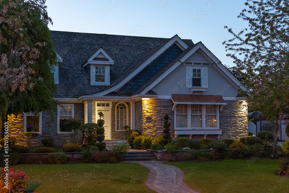 Obraz premium Two story stucco luxury house with nice Spring blossom landscape at night in Vancouver, Canada, North America. May 2025.