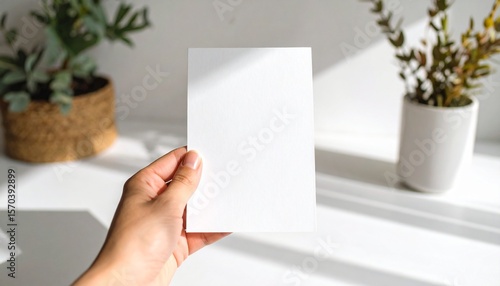 A5 Flyer mockup in hand, paper blank template brochure, Side lit. with white shades