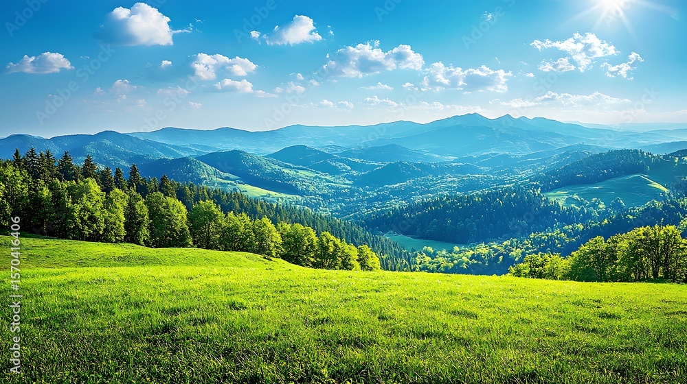 Naklejka premium Vibrant green hills under a bright blue sky with scattered clouds and distant mountains.