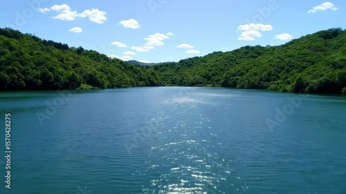 Wallpaper Mural Serene lake nestled in lush green hills Torontodigital.ca