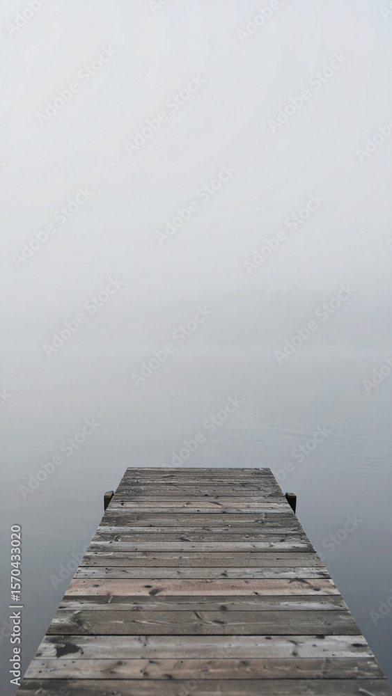Fototapeta premium Wallpaper of Wooden Dock At Lake With Misty Background