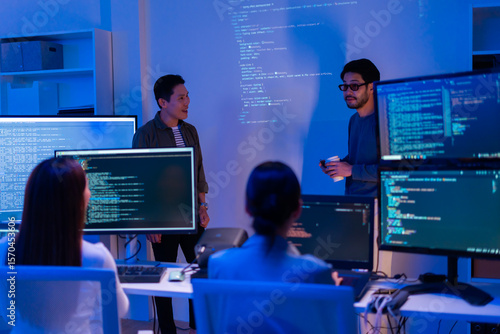 Bild auf Leinwand Asian software engineer or programmer team working late in development office,problem solving or algorithm of ai assistant helping for work