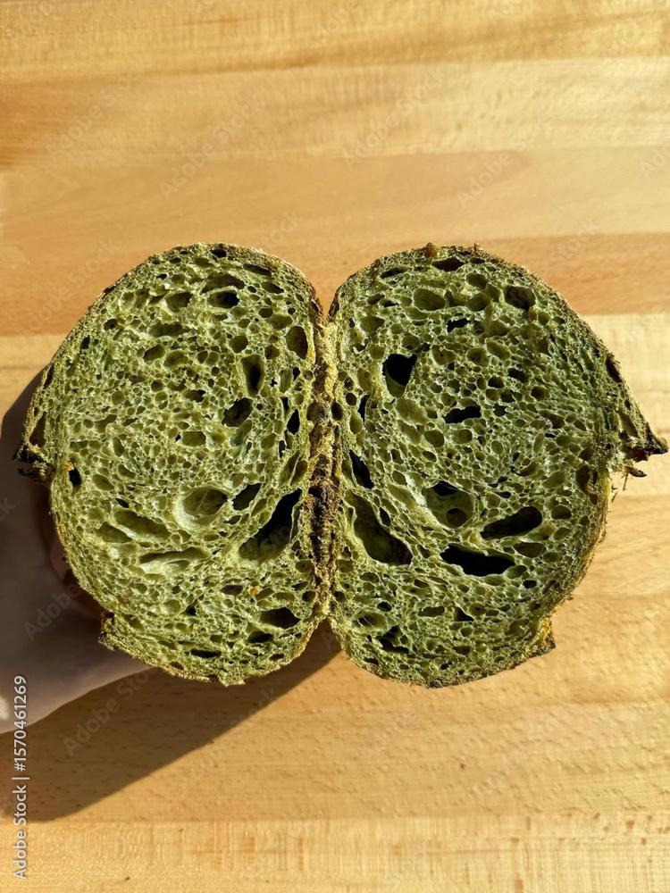 Fototapeta premium Matcha sourdough loaf sliced to expose crumb.