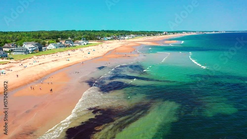 Wallpaper Mural Aerial drone video of Saco, Maine coastline in summer. Tourists fill the sandy beach near vacation houses, waves hit shore, families relax. A beautiful East Coast getaway in full peak-season swing. Torontodigital.ca
