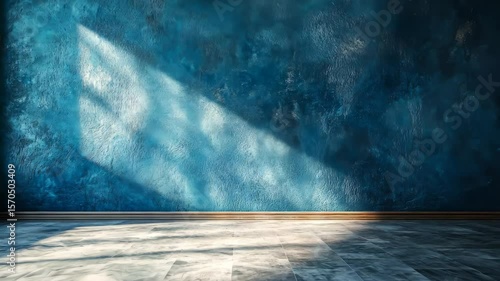 Bright sunlight casts dramatic shadows on a textured blue wall in a serene indoor space