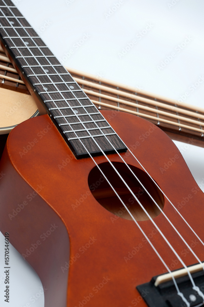 Obraz premium Four-string bass ukulele with wooden body and built-in tuner and pickup.