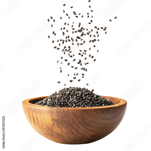 Chia seeds falling into wooden bowl superfood healthy eating antioxidant rich diet food