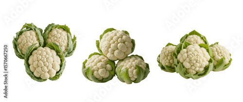 Close up view of fresh cauliflower heads with green leaves isolated on white background showcasing