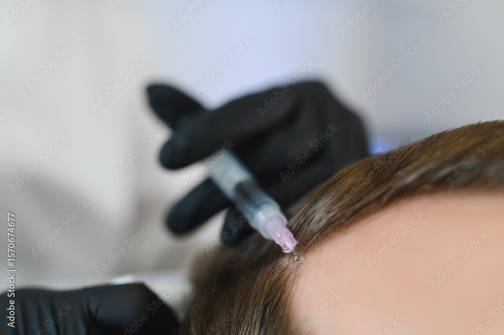 Naklejka premium Man getting hair treatment at beauty salon, having mesotherapy session. Female therapist hands in protective gloves making injection with syringe