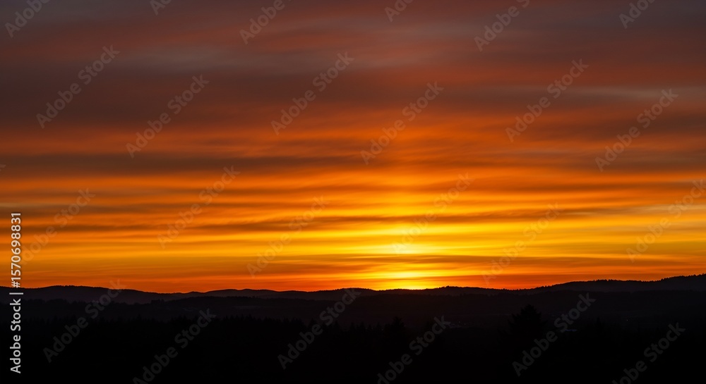 Vibrant Orange Sunset over Silhouetted Mountain Range and Forest Landscape Vibrant Orange Sunset over Silhouetted Mountain Range and Forest Landscape