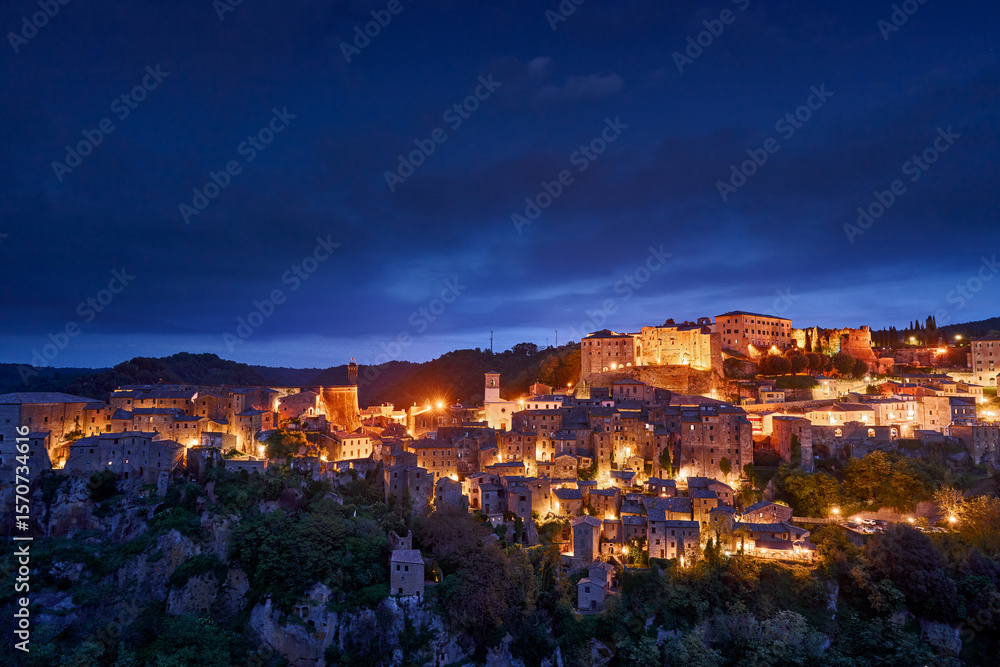 Obraz premium Sorano, Tuscany in Italy. A small medieval town on a cliff. Night city lights. Village in the rock, travel in Europe. Night city lights in night, Italy
