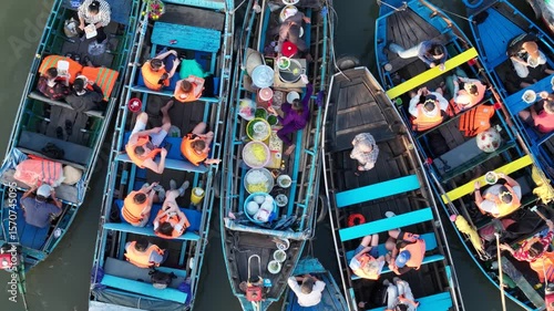 Drone view of busy boats at Cai Rang Floating Market in Can Tho, Vietnam, during a vibrant morning scene.	
