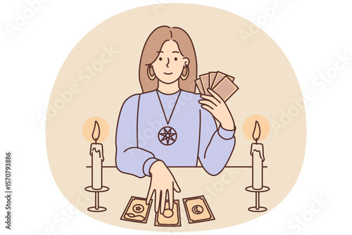 Woman with Tarot cards in form of witch sits at table and predicts future being fortune teller