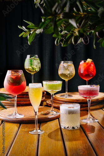 Colorful cocktail selection showcased at a stylish bar during evening hours
