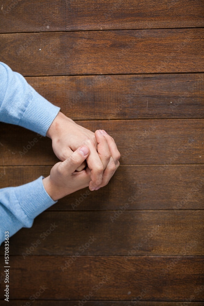 Naklejka premium Man praying on wooden table
