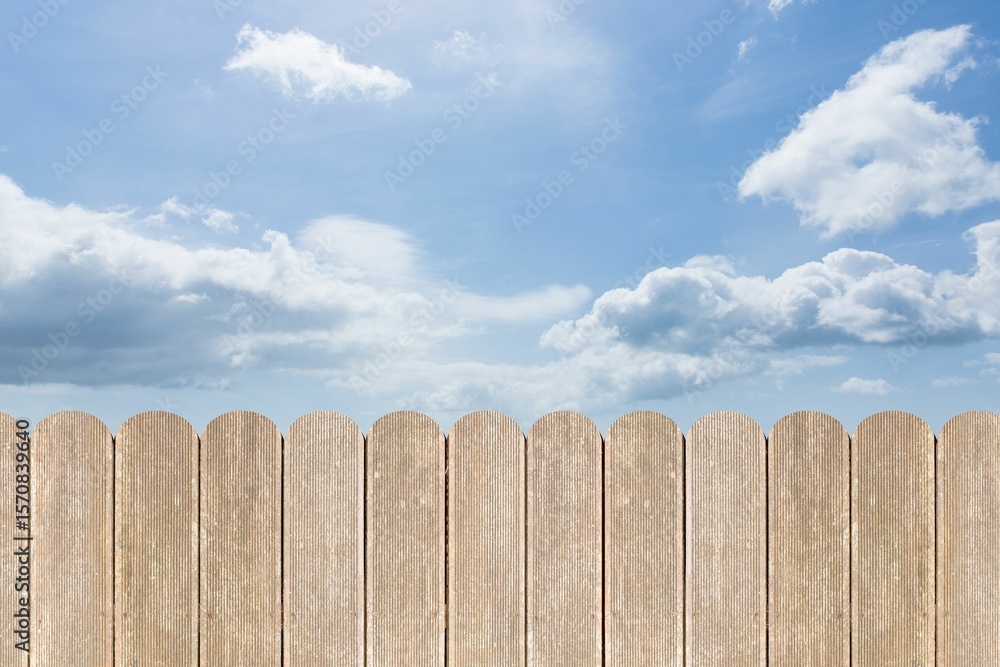Fototapeta premium Flat design vertical wooden slat fence is stretching under bright blue sky dotted with clouds