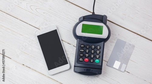 Payment devices are showing on white table, flat design featuring smartphone, reader, credit card