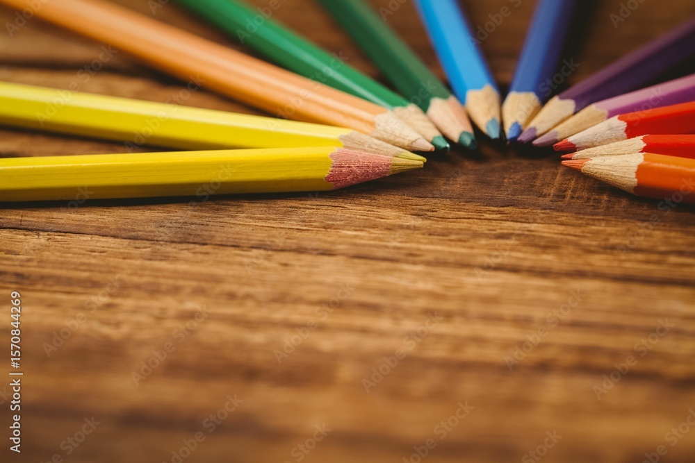 Fototapeta premium Color pencils arranged on wooden table