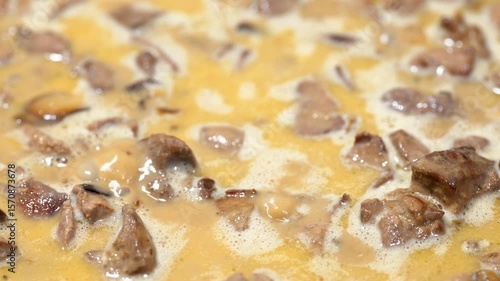 Cooking fried pork pieces in a frying pan. Pork, Beef, Chicken fillet. Cooking boiled meat, goulash with vegetables in a creamy sauce in a frying pan in the kitchen. Cook homemade food meat dish.