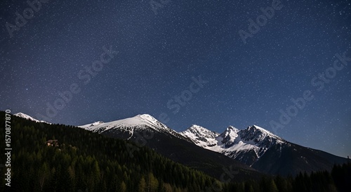 Majestic Snowy Mountain Peaks Under a Brilliant Starry Night Sky