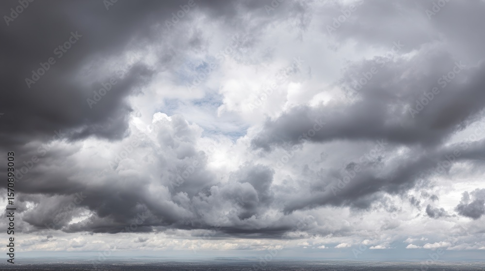 Obraz premium The Dramatic Sky Covered with Fluffy Gray Clouds Over the Horizon