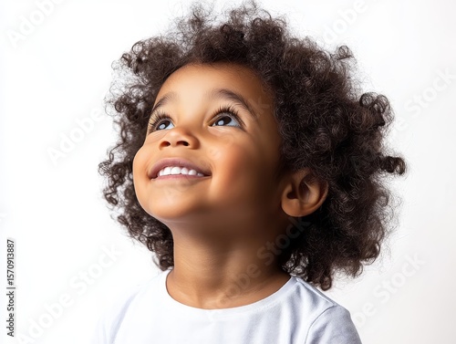 Portrait of a smiling African American kid looking up, happy little child isolated on white background, realistic photo.