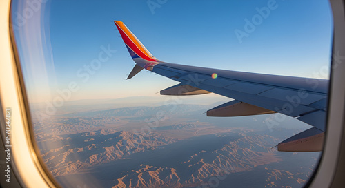Southwest Airlines wing soars above a desert landscape viewed from airplane