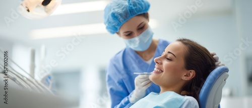 The dental professional providing gentle care to a smiling patient in clinic.