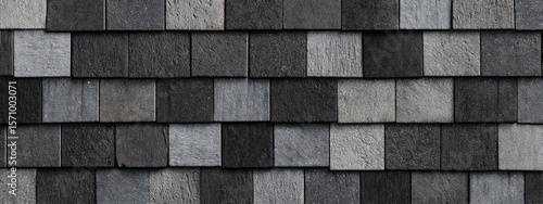 Interlocking gray and black wood shingle roof texture, showing varied tones and grain
