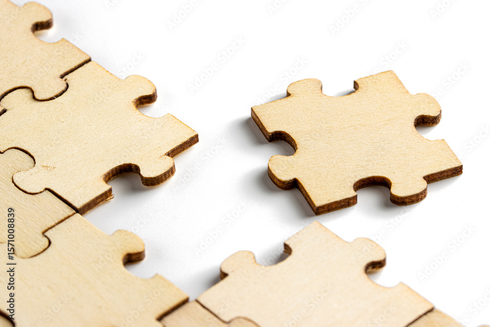 Fototapeta premium incomplete puzzle pieces, with seperated final pieces. Work and business concept with white background.