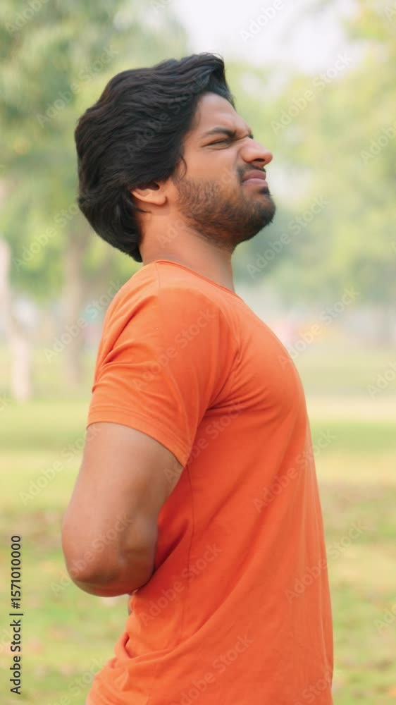 Vertical Sot of Young Indian Man Having Back Pain Vertical Sot of Young Indian Man Having Back Pain