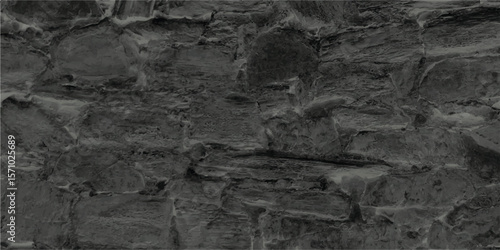 Textured stone wall background in monochromatic gray tones illustrating weathered and aged construction detail