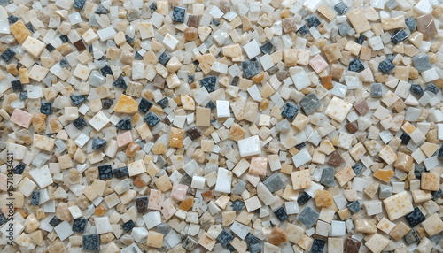 A vibrant, high-angle view of terrazzo-style glass tiles in a mosaic pattern, showcasing a mix of beige, white, and subtle dark fragments.