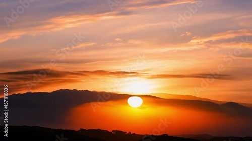 Beautiful time lapse of the sun setting behind the clouds.