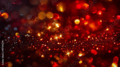 Sparkling red and gold bokeh background with festive glow and glitter effect