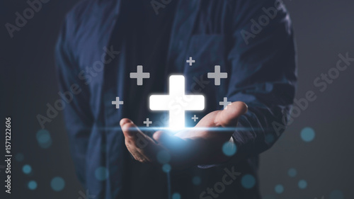 Wallpaper Mural Businessman holding glowing plus signs, symbolizing corporate social responsibility, motivation, growth, and positive impact in business or community development. Torontodigital.ca