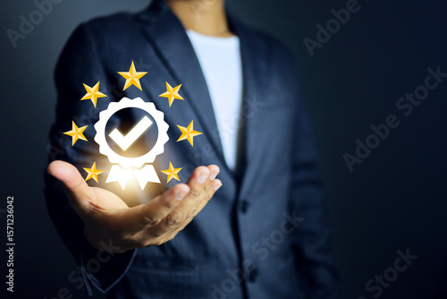 Obraz na plátně certificate concept with businessman holding the certified mark and star represe