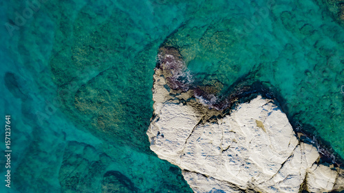 Aerial view of white rocky coastline in Syria. Rocks on coast beautiful sea bay at Latakia beach. Natural landscapes by the sea.