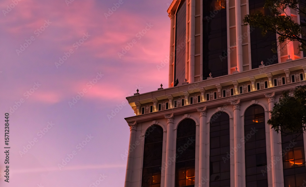 Fototapeta premium Close-up view of a modern building's architectural details against a stunning dusk sky. Blend of contemporary design with the soft colors of twilight.