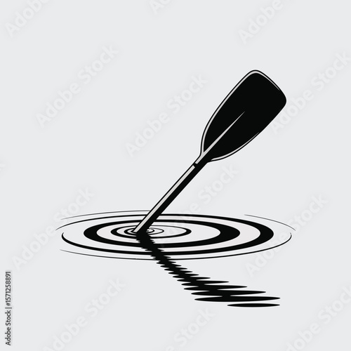 Black canoe paddle dipping into water creating ripples and reflection